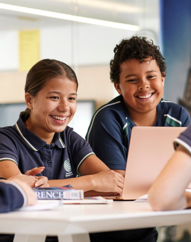 Kids looking at computer smiling